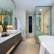 Designer bathroom complete with cantilevered vanity, freestanding tub 