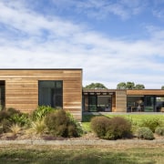 The north-east elevation of the cedar weatherboard-clad home. 