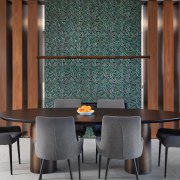 A feature tiled mosaic wall stands between dining 