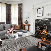 Family room with exotic rug and custom fire 