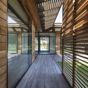 Cedar screens contrast the silvered timber walkways and 