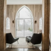 The ogival windows preserve the historical aspect of arch, architecture, building, ceiling, chair, couch, curtain, design, door, floor, flooring, furniture, home, house, interior design, living room, loft, property, real estate, room, window, gray, brown