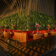 Dining area with arresting tropical/organic backdrop. 