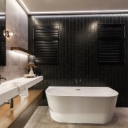 The bath is positioned in front of the 