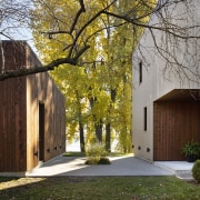 Light-toned cladding on the exterior of the main brown, gray, black