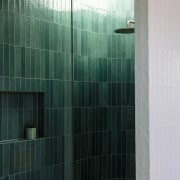 Feature tiled shower with skylight letting sunlight pour 