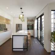 Sunlit kitchen with herringbone feature splashbacks and contemporary 