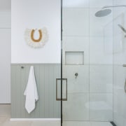 Large-format tiles give the shower a sense of 