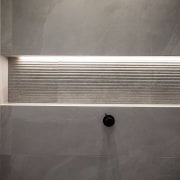 The rippled tiles also feature in the shower 