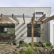 Victorian Ash timber beams of the pergola continue 