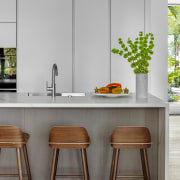 The modern kitchen showcases products by Ernesto Meda, 