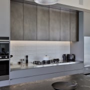 The colour/material palette of taupe grey and bronzed architecture, countertop, cuisine classique, interior design, kitchen, light fixture, under cabinet lighting, gray