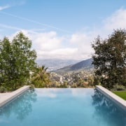 Com trails overhead while the infinity edge pool 