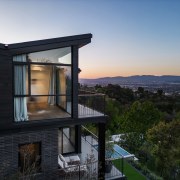 Exterior view of upstairs bedroom with private balcony. 