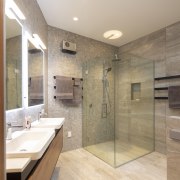 The custom glass shower stall adds to the 