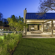 House and pool under an evening sky. - 