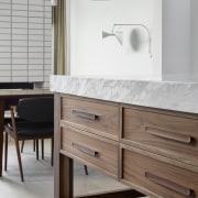 The walnut and marble island is designed to 