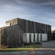 The wooden elements of this home's facade will gray