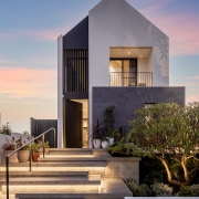 A pleasing layering of underlit front steps leads 