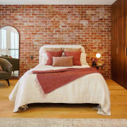 Master bedroom with feature brickwork and built-in custom 