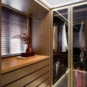 The walk-in wardrobe has high-end custom millwork, designed 