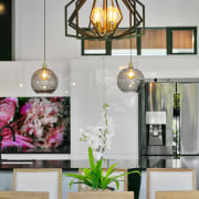 A sumptuous colourful splashback and chic, contemporary lighting 