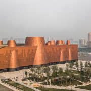 The central atrium rises like a giant cone architecture, atmospheric phenomenon, building, city, cityscape, facade, human settlement, landmark, landscape, metropolis, metropolitan area, mixed-use, residential area, roof, sky, skyscraper, urban area, urban design, gray, brown