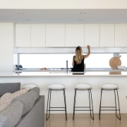 The all white kitchen provides a neutral backdrop building, ceiling, countertop, design, dining room, floor, flooring, furniture, home, house, interior design, kitchen, living room, material property, property, room, table, white
