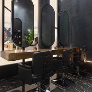 The fit-out creates an immersive environment removed from architecture, building, design, floor, flooring, furniture, interior design, living room, room, table, black