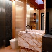 A skylight bathes the exotic marble in natural 