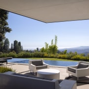 An infinity edge pool connects the home to 