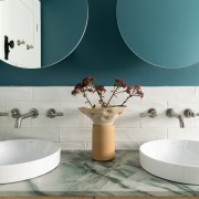 A custom vanity with vessel basins and a 