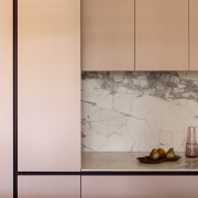 Custom joinery incorporates integrated handles and shadowlines for 
