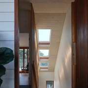 The CLT staircase has skylights above, flooding natural 