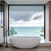 The master suite frames the serene views with 