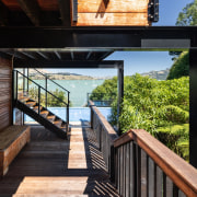 Beneath the terraced outdoor living area. - Through 