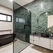 The main bathroom complete with green tilework and 