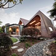 The overhanging roof forms manage the impact of 