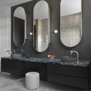 Floating vanity with three large mirrors fronting slender 