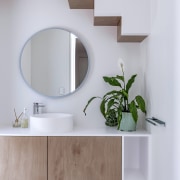 Bathroom vanity with intimations of the staircase above. 