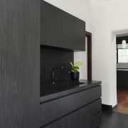 The existing wood floors contrast the black and 