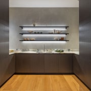 Underlit open shelving greets entry into the large 