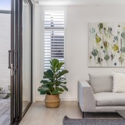 Sliding glass panels make for easy indoor-outdoor floor building, curtain, door, floor, flooring, furniture, home, house, houseplant, interior design, living room, plant, property, real estate, room, table, tile, wall, wallpaper, window, window covering, window treatment, gray