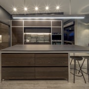 Dark-toned and linear, this kitchen matches the character gray, black