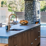 Contemporary kitchen island offers ideal vantage on outdoor 