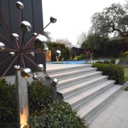 A garden sculpture next to the new pool 