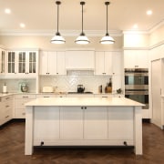 Classic pendants are matched with modern slender countertops building, cabinetry, ceiling, countertop, cuisine classique, cupboard, floor, flooring, furniture, hardwood, home, house, interior design, kitchen, light fixture, lighting, material property, property, real estate, room, sink, tile, wood flooring, orange