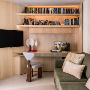 Curved, pale timber joinery features throughout the apartment. 