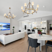 The kitchen's white tones continue in the adjacent 