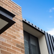 Old meets new in the expanding villa renovation. architecture, blue, brick, brickwork, building, daylighting, daytime, facade, home, house, line, material property, property, real estate, residential area, sky, wall, window, teal